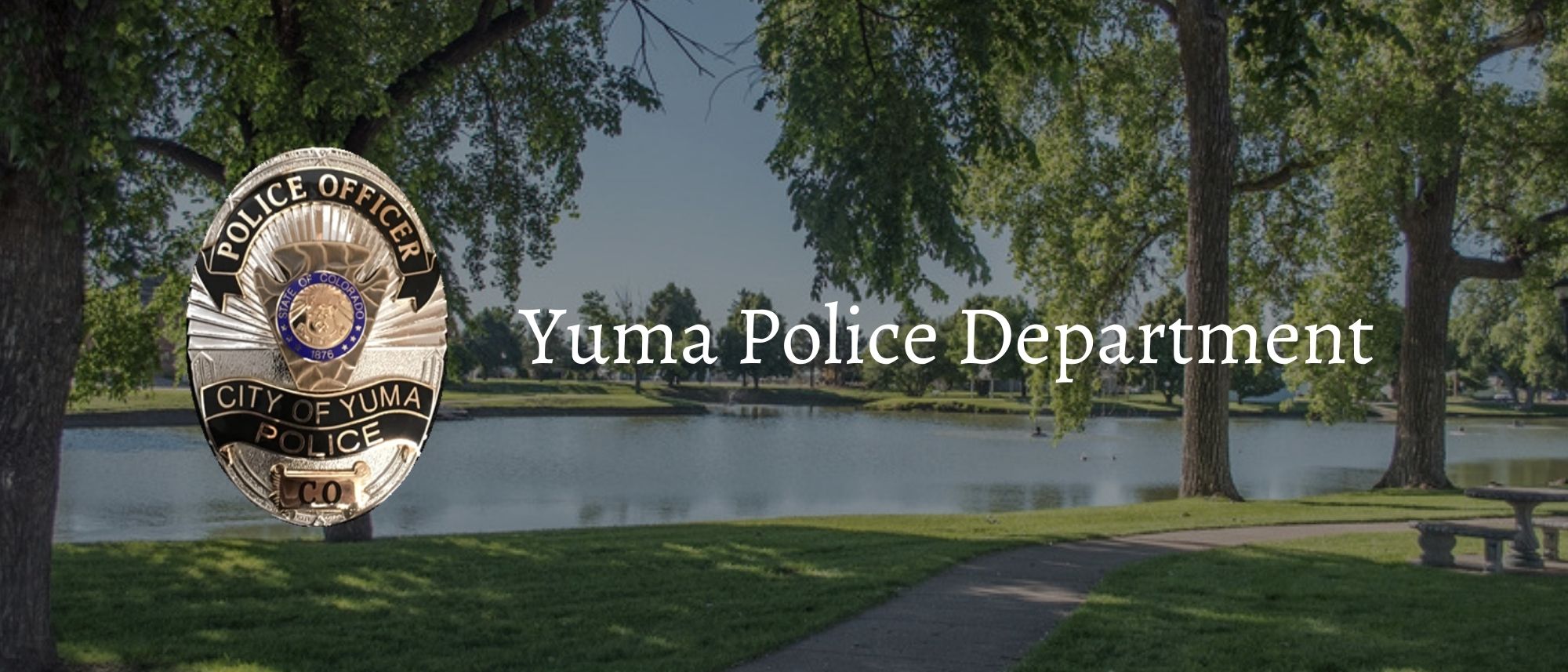 Yuma Police Department badge in front of a Yuma park